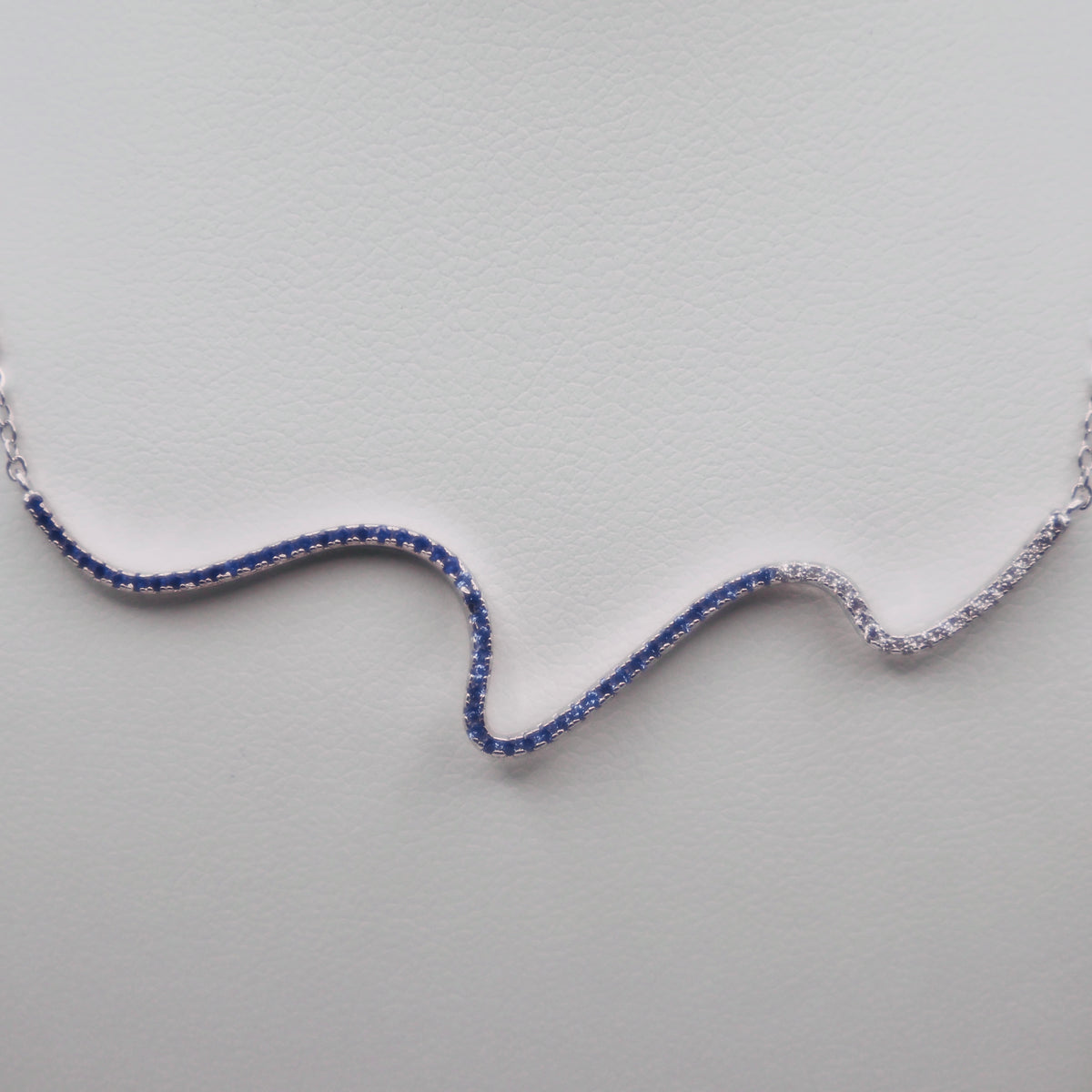 Genuine Sterling Silver Squiggle Line Necklace with clear, sky blue, and dark blue Cubic Zirconia
